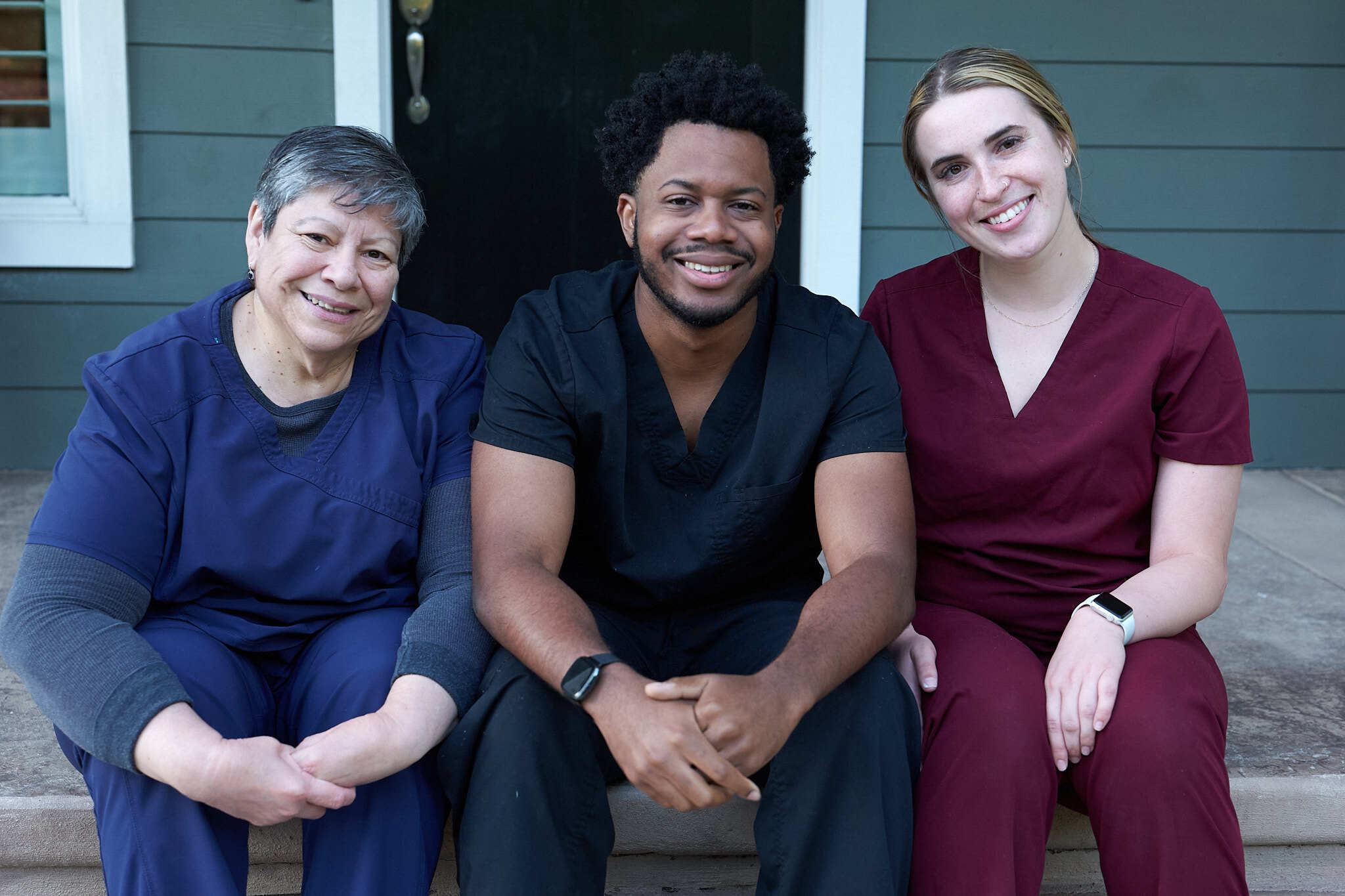 Caregivers sitting and smiling together.